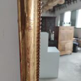 Long wooden mirror and gilded stucco with pearl rays H: 2m45 L: 40cm