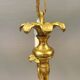 Older brass alloy chandelier with three light sources.