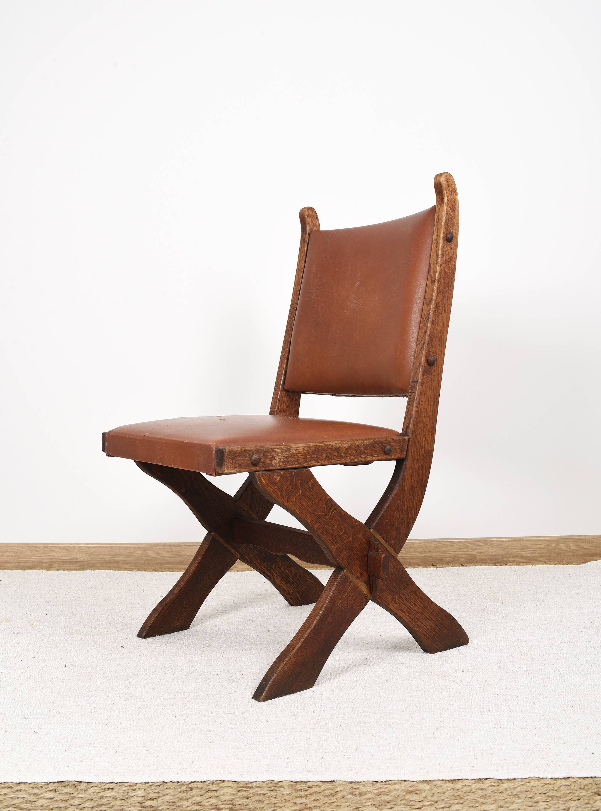 Pair of brutalist style chairs, in wood and leather.