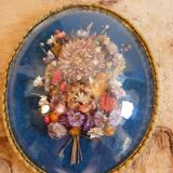 Oval frame bouquet of dried flowers with curved glass