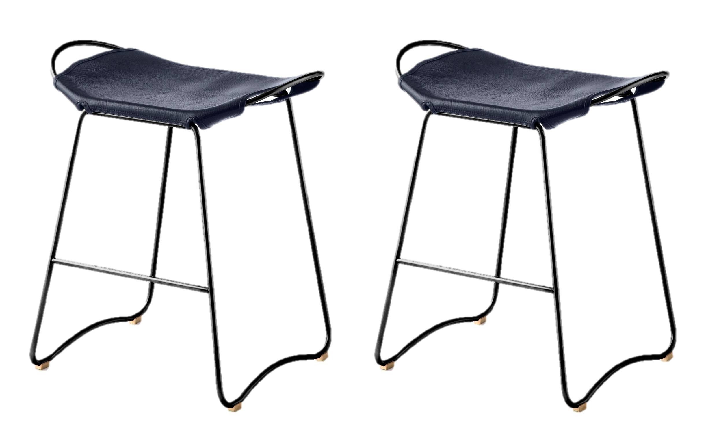 A pair of comfortable stools, blue with black metal details.
