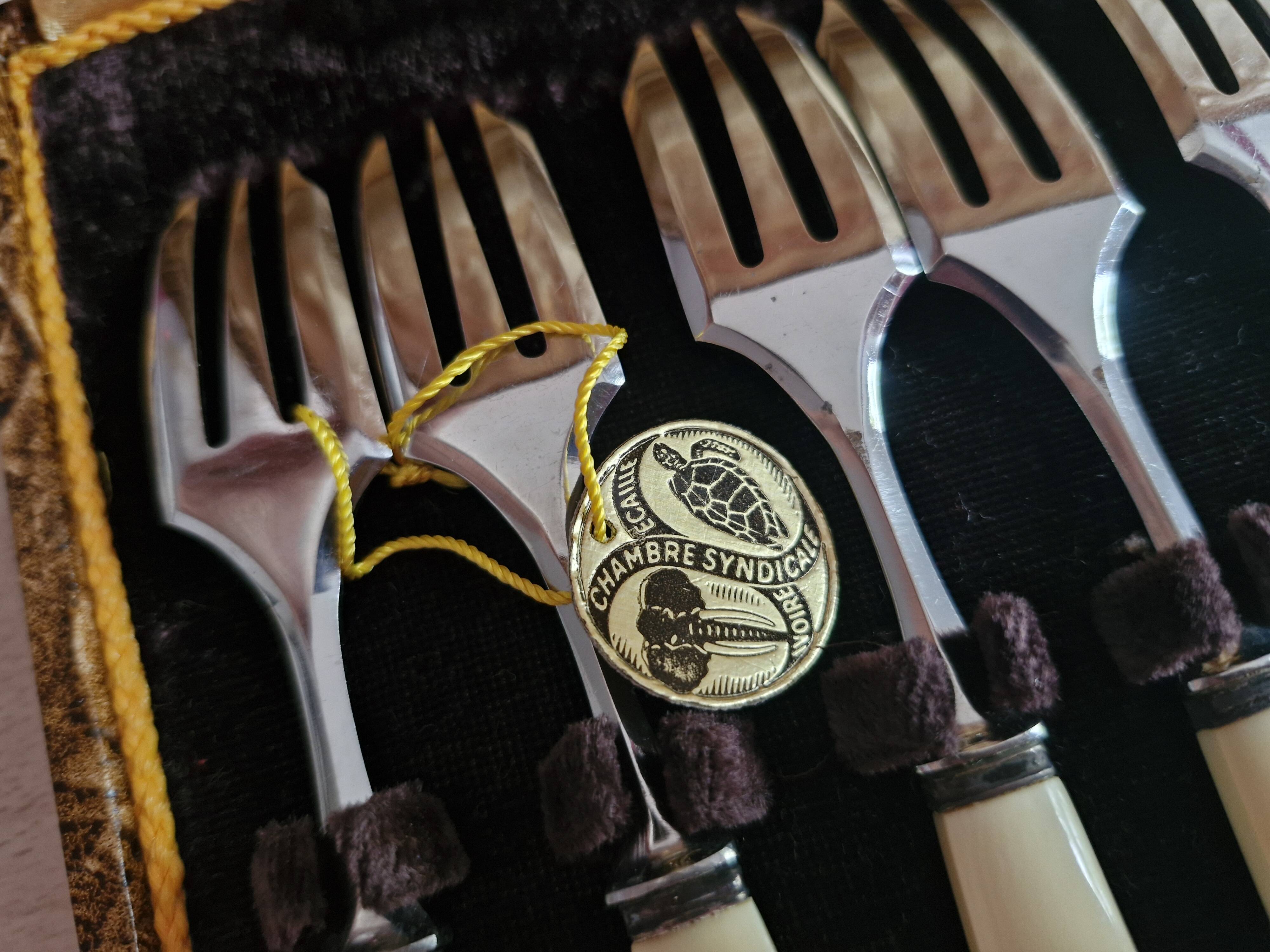 Service of 12 dessert forks with ivory handles.