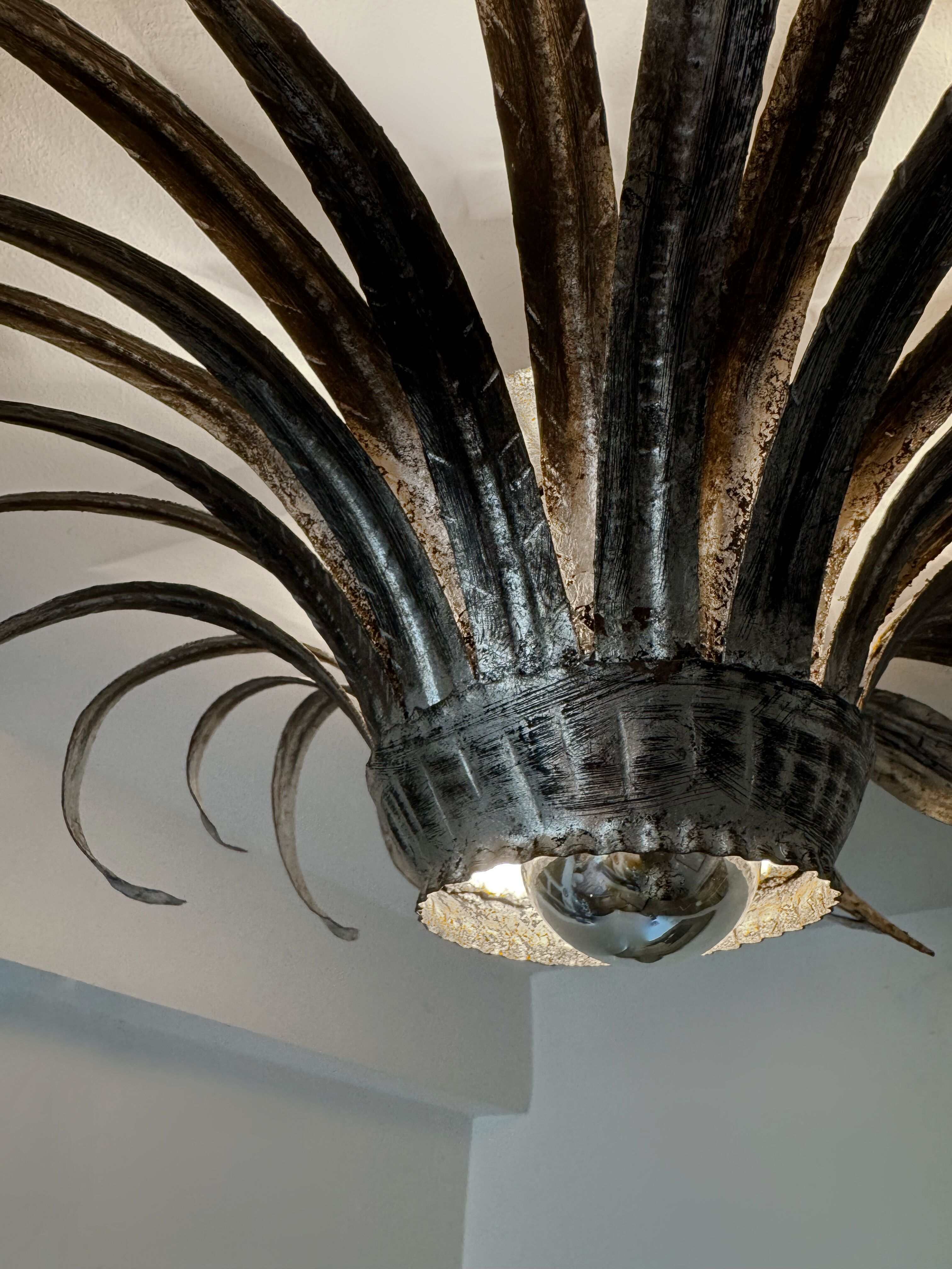 Silver wrought iron sunburst wall light from the 1960s.