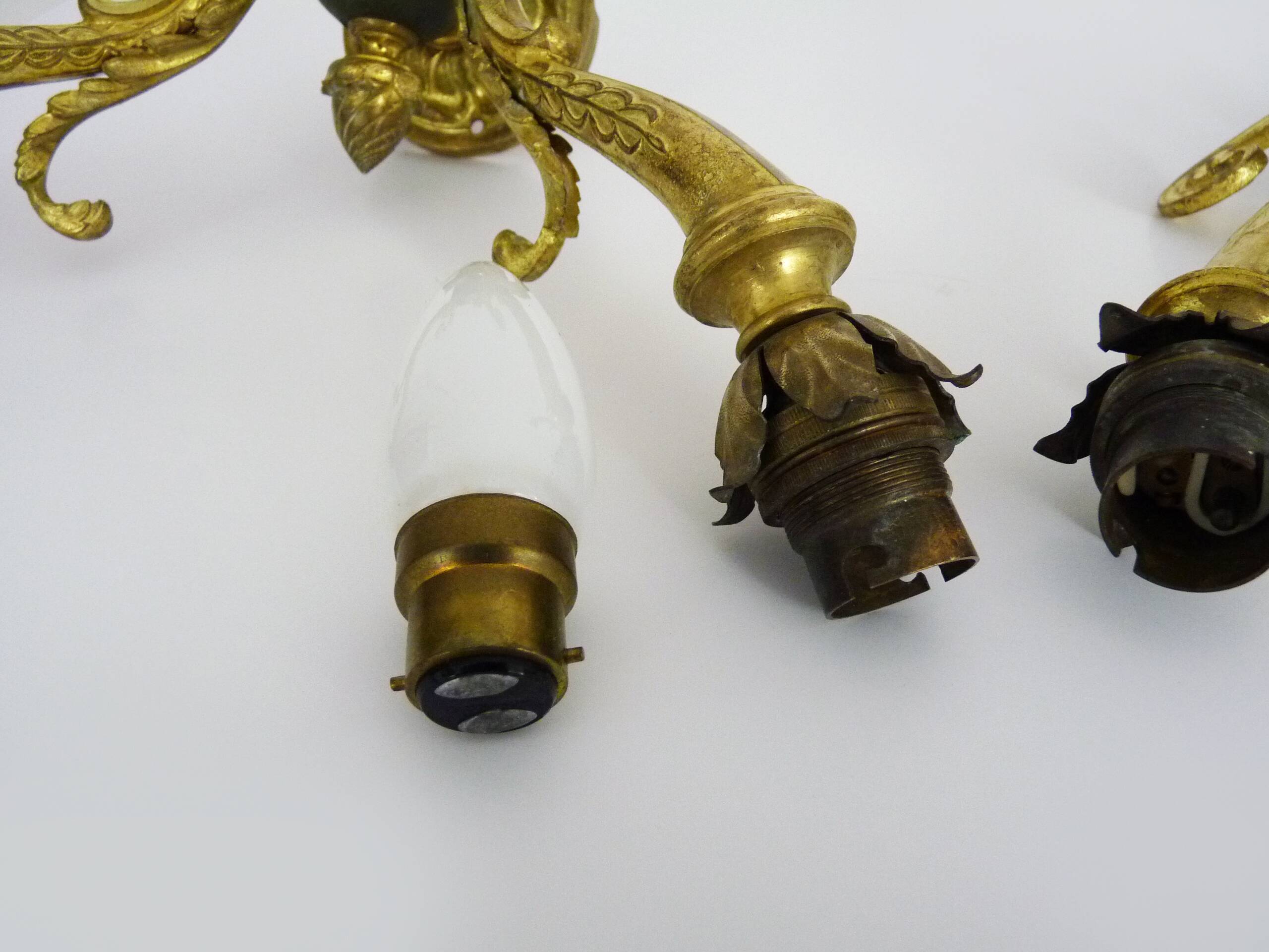 Pair of double-light Empire style wall lights in bronze