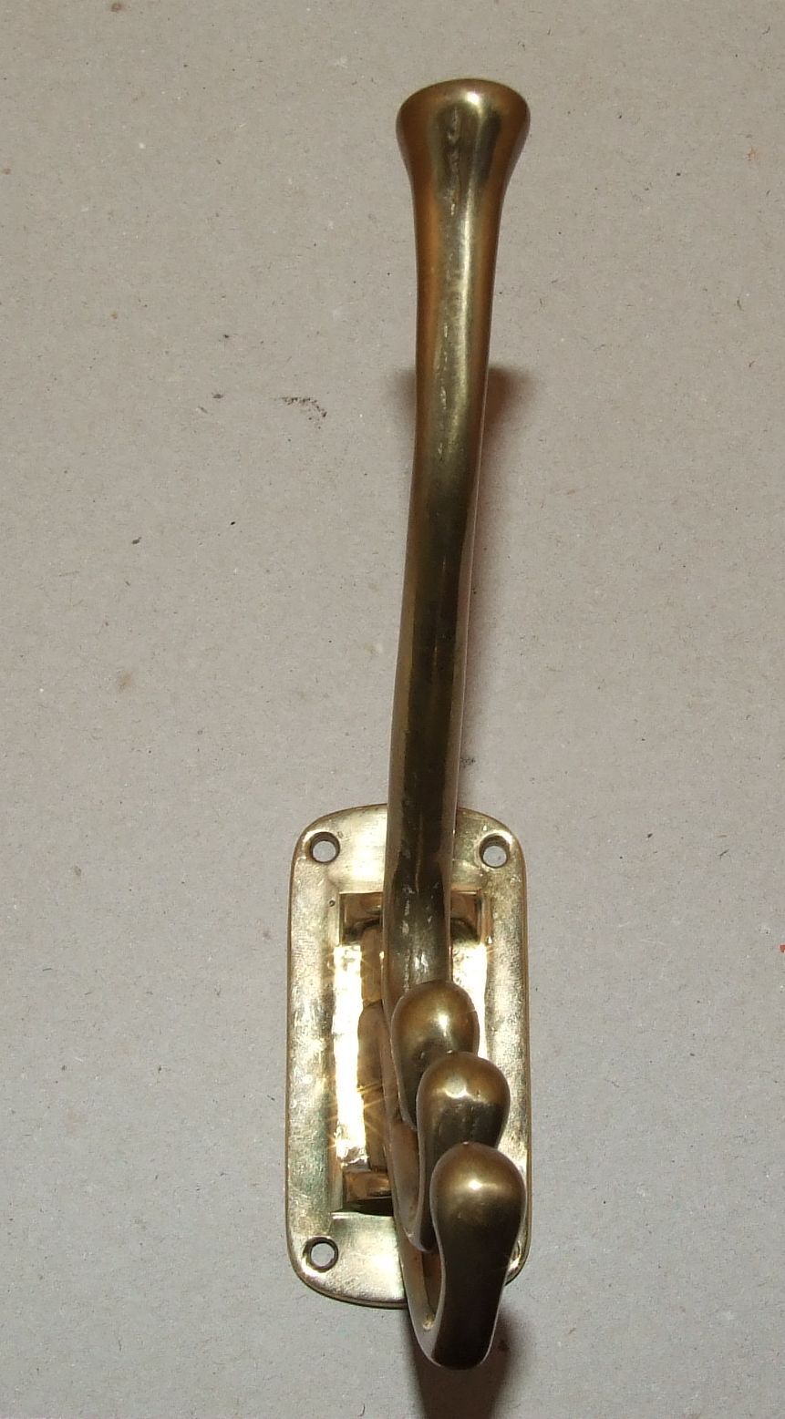 Articulated brass patère
