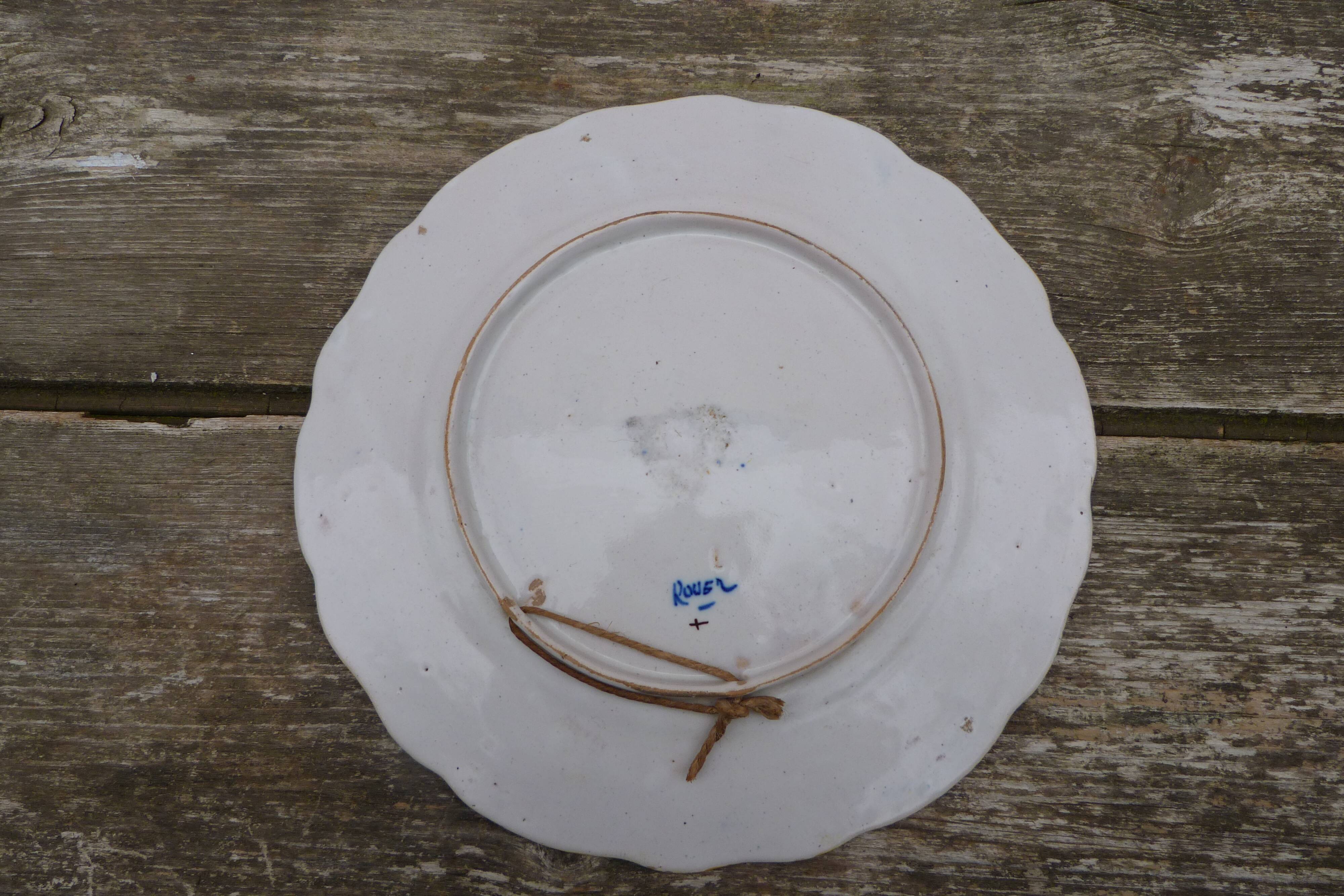 18th century plate in Rouen's faience with coat of arms and floral motifs