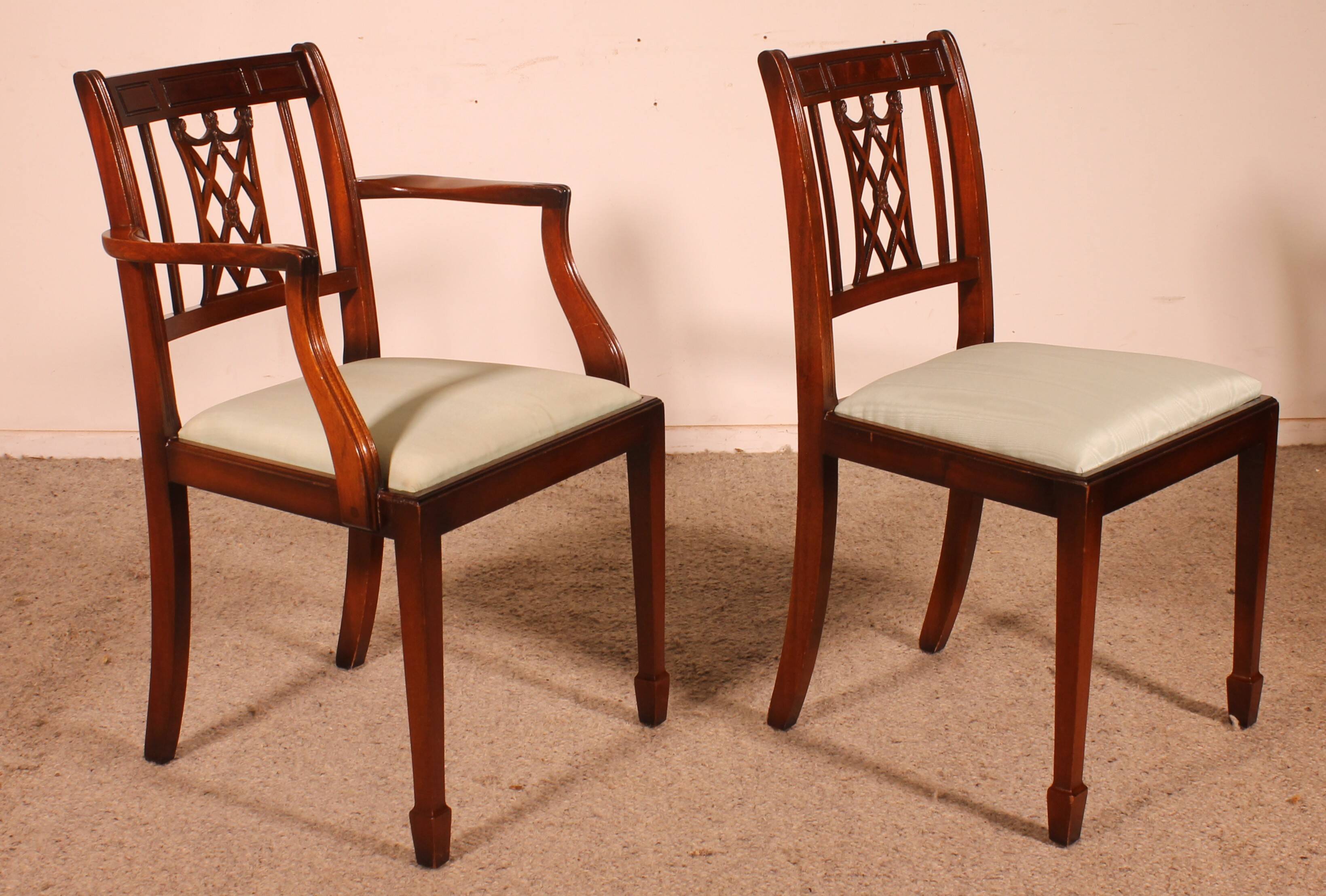 set of 10 chairs and two mahogany armchairs in Hepplewhite style