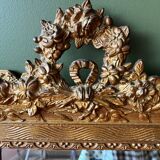 Golden trumeau mirror for fireplace, late 19th century, with sculpted pediment.
