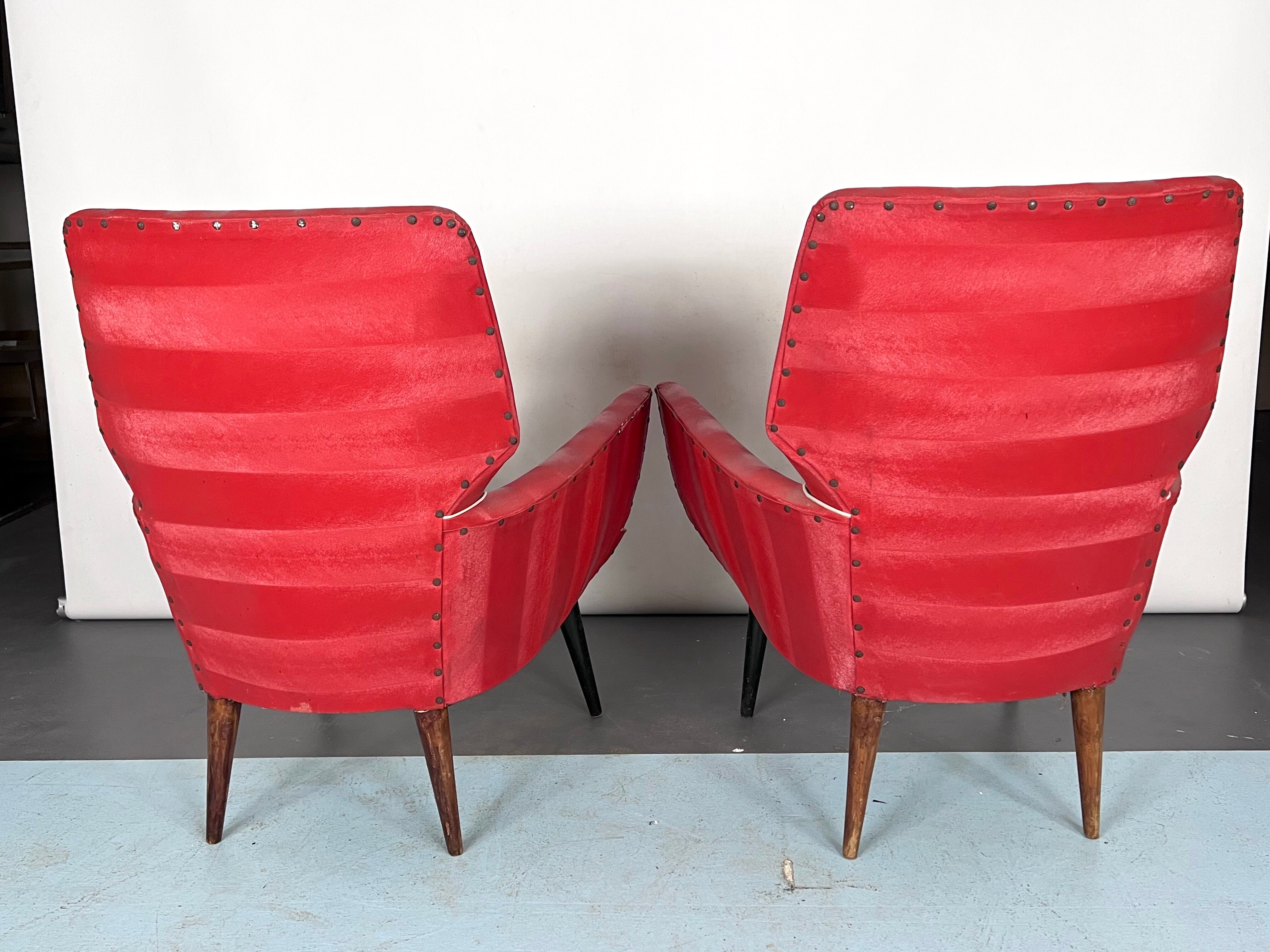 Mid-century modern pair of red armchairs. italy 1950s