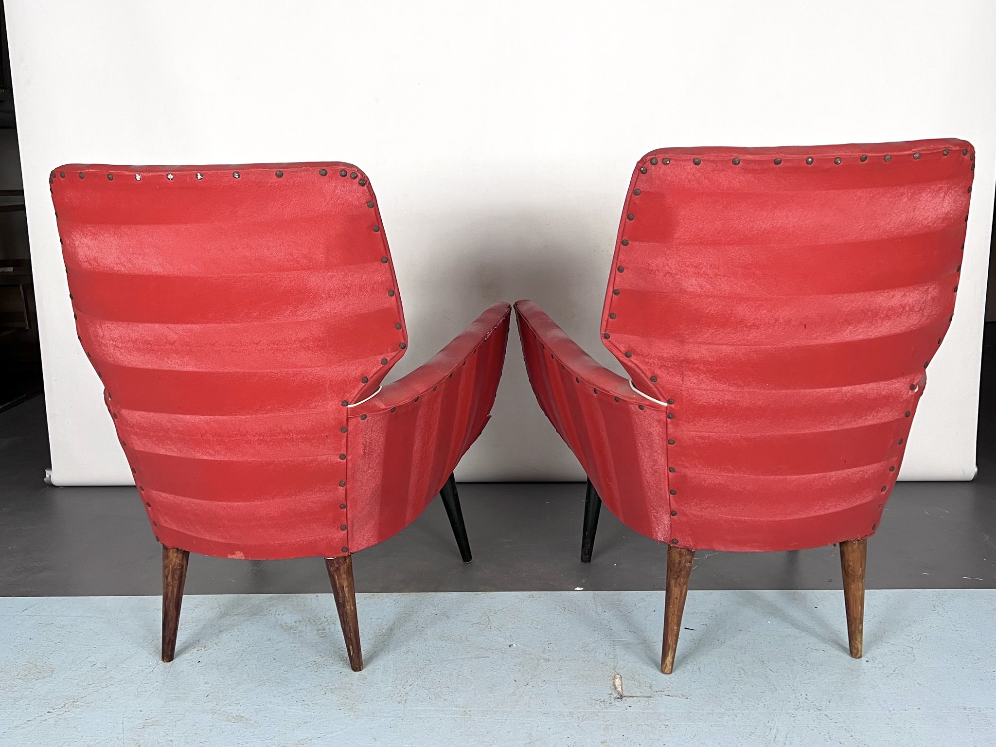 Mid-century modern pair of red armchairs. italy 1950s
