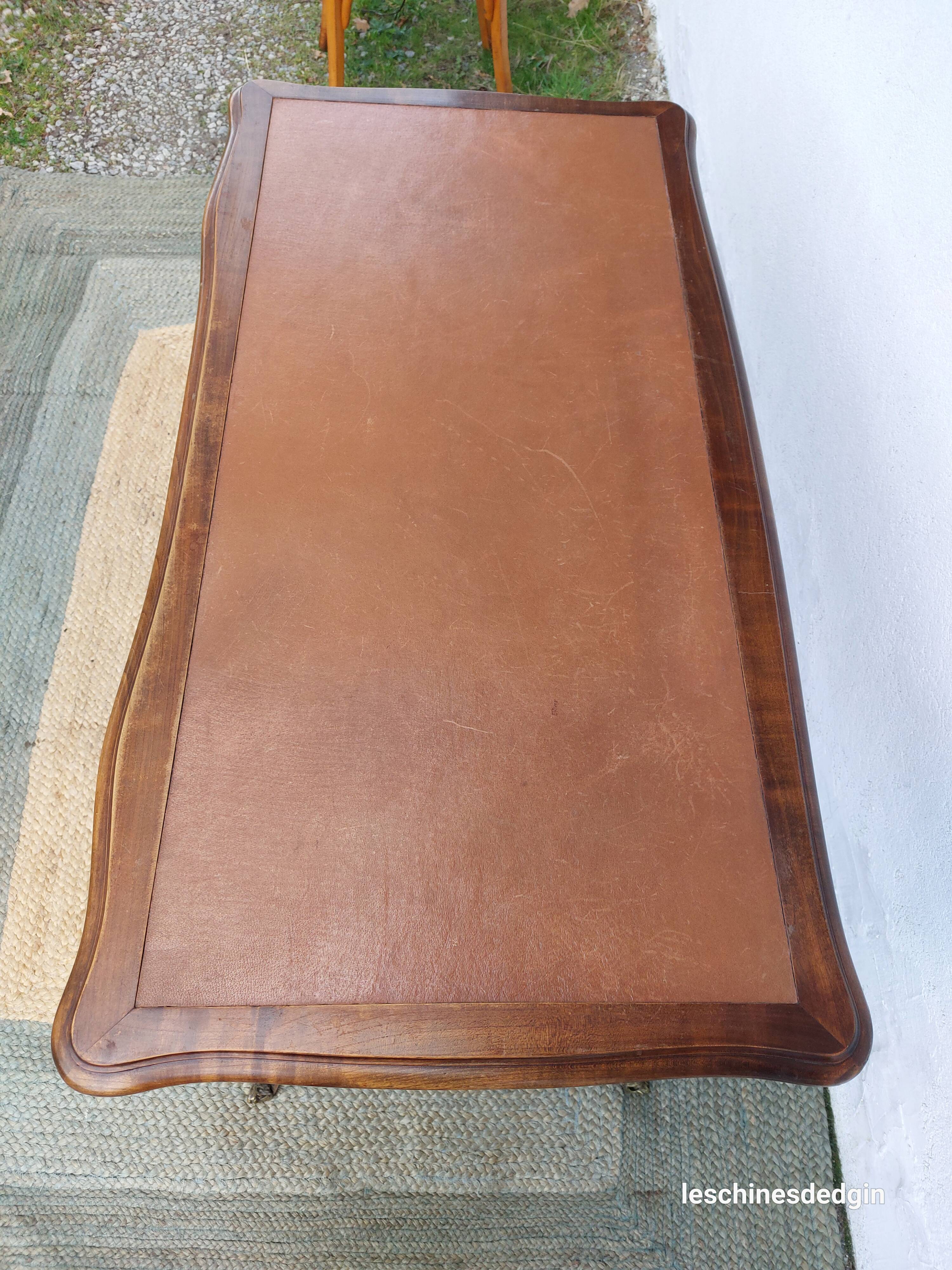 Louis XV style desk in wood, with a brown leather top.