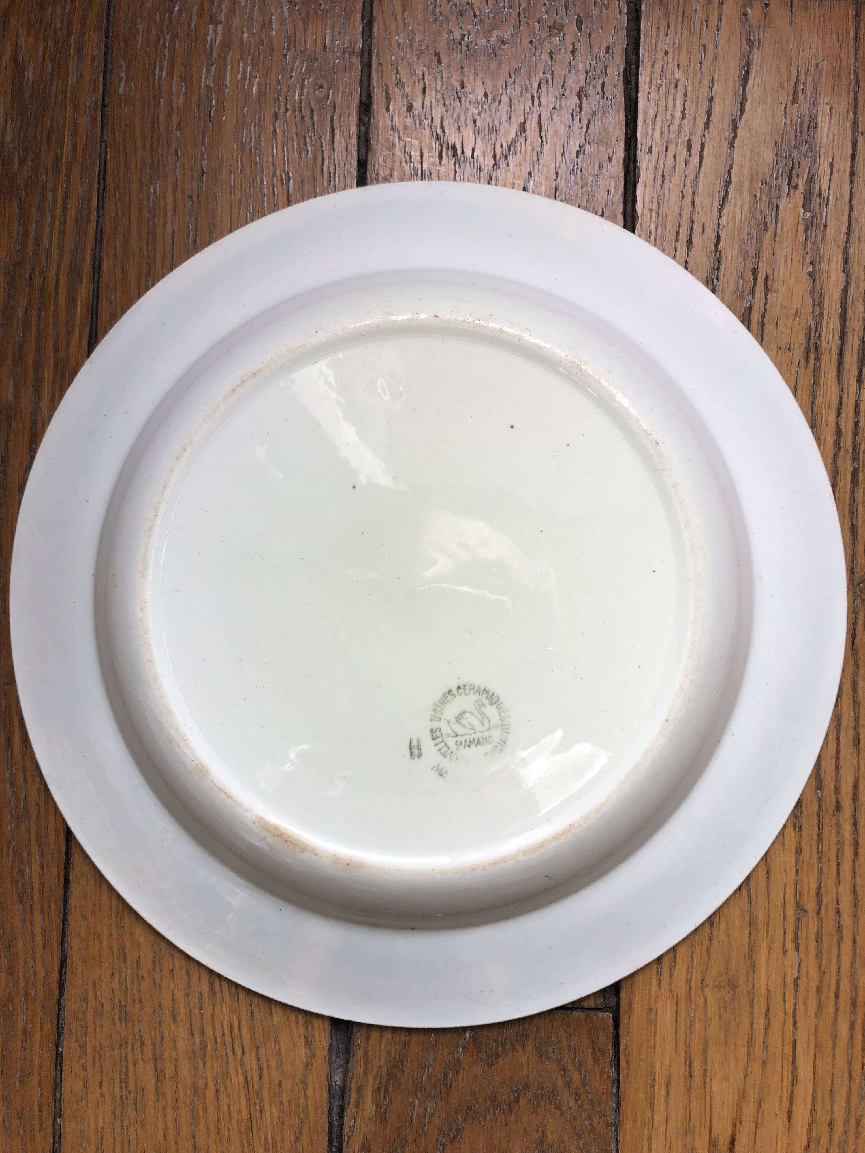 Vintage hollow serving dish with a decoration: marsh landscape.