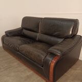 Black leather sofa and wooden armrests