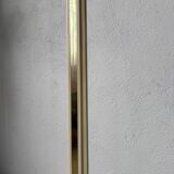 Floor lamp with articulated arm in brass-plated metal