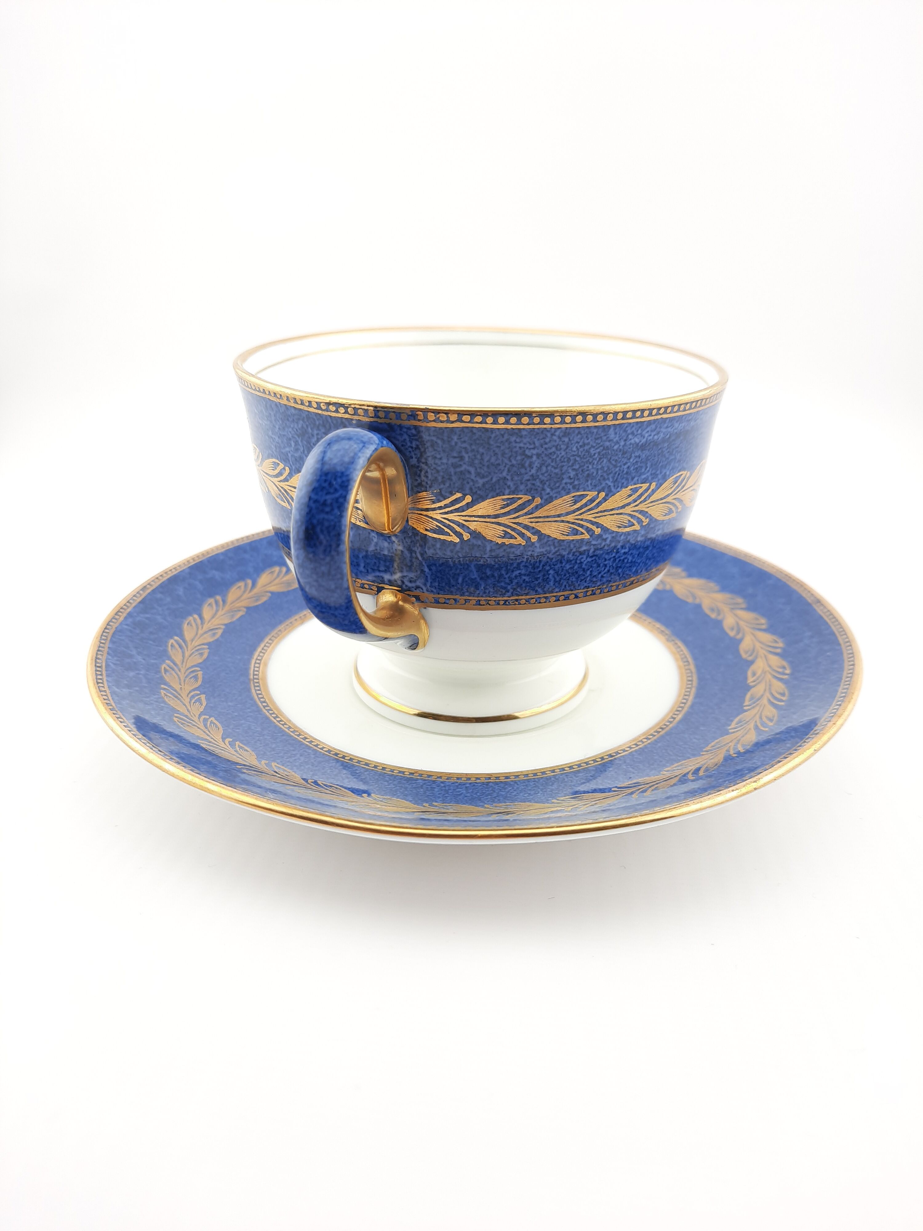 Antique Wedgwood teacup and saucer, bone china. Powder blue and gold English footed cup and saucer,