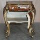 Pair of curved walnut commodes with marquetry and marble tops.