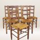 Set of six rush-seated ladderback chairs.