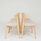 Set of 6 pale pink dining chairs in natural wood.