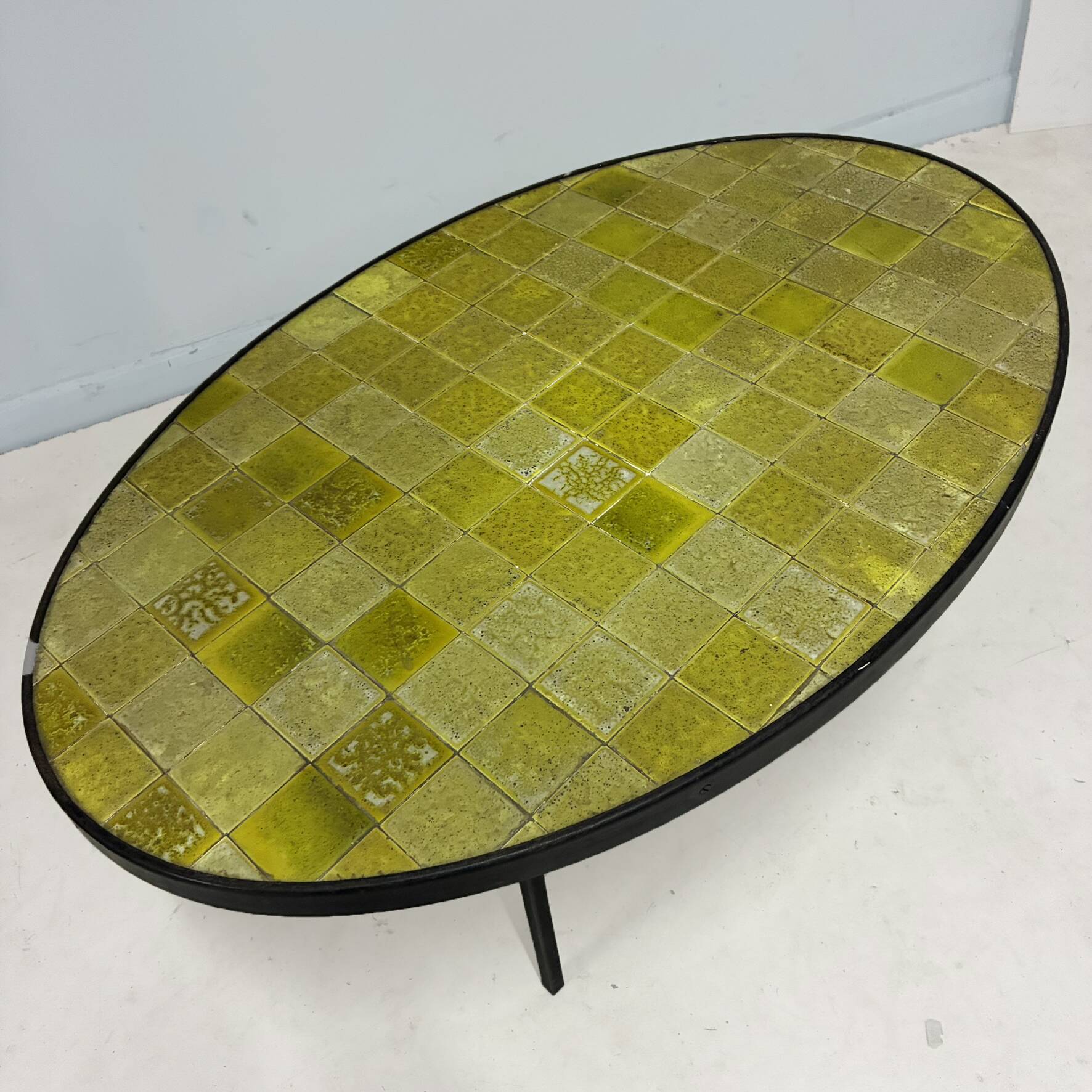 Oval coffee table in glazed ceramic and black metal, DLG by Mado Jolain.