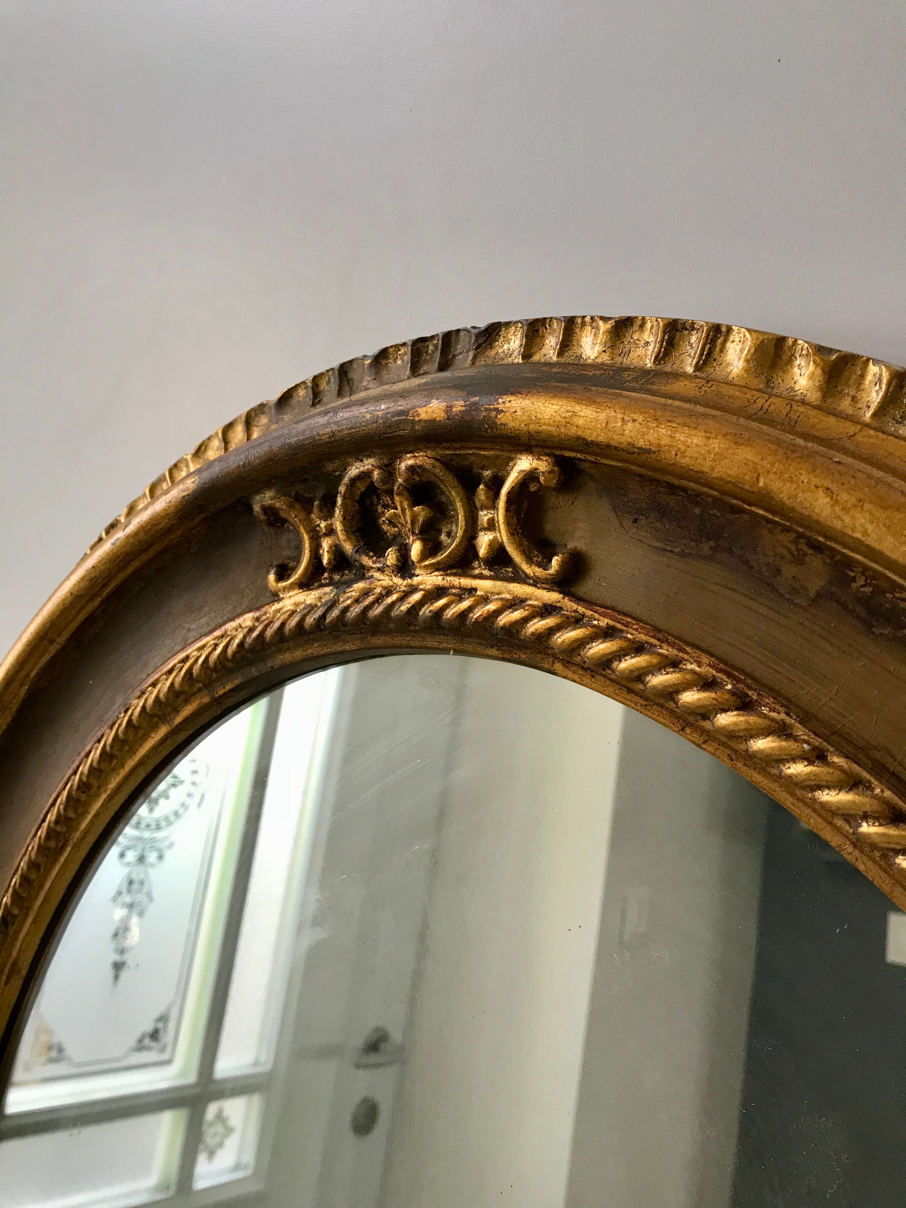 Grand miroir oval en stuc doré vintage