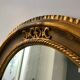 Grand miroir oval en stuc doré vintage