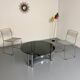 Round coffee table in smoked glass and chrome steel, 1970s design.