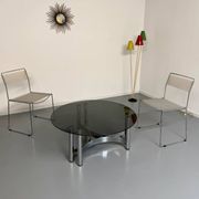 Round coffee table in smoked glass and chrome steel, 1970s design.