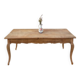 Curved farmhouse table in rustic wood, Provençal style.