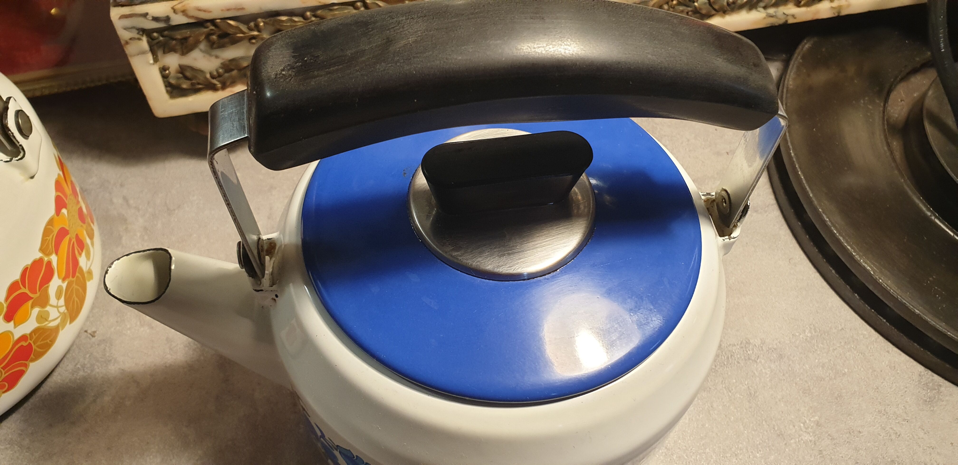 Vintage kettle in blue enamelled sheet metal