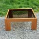 Coffee table from Regain in solid elm with a smoked glass top.