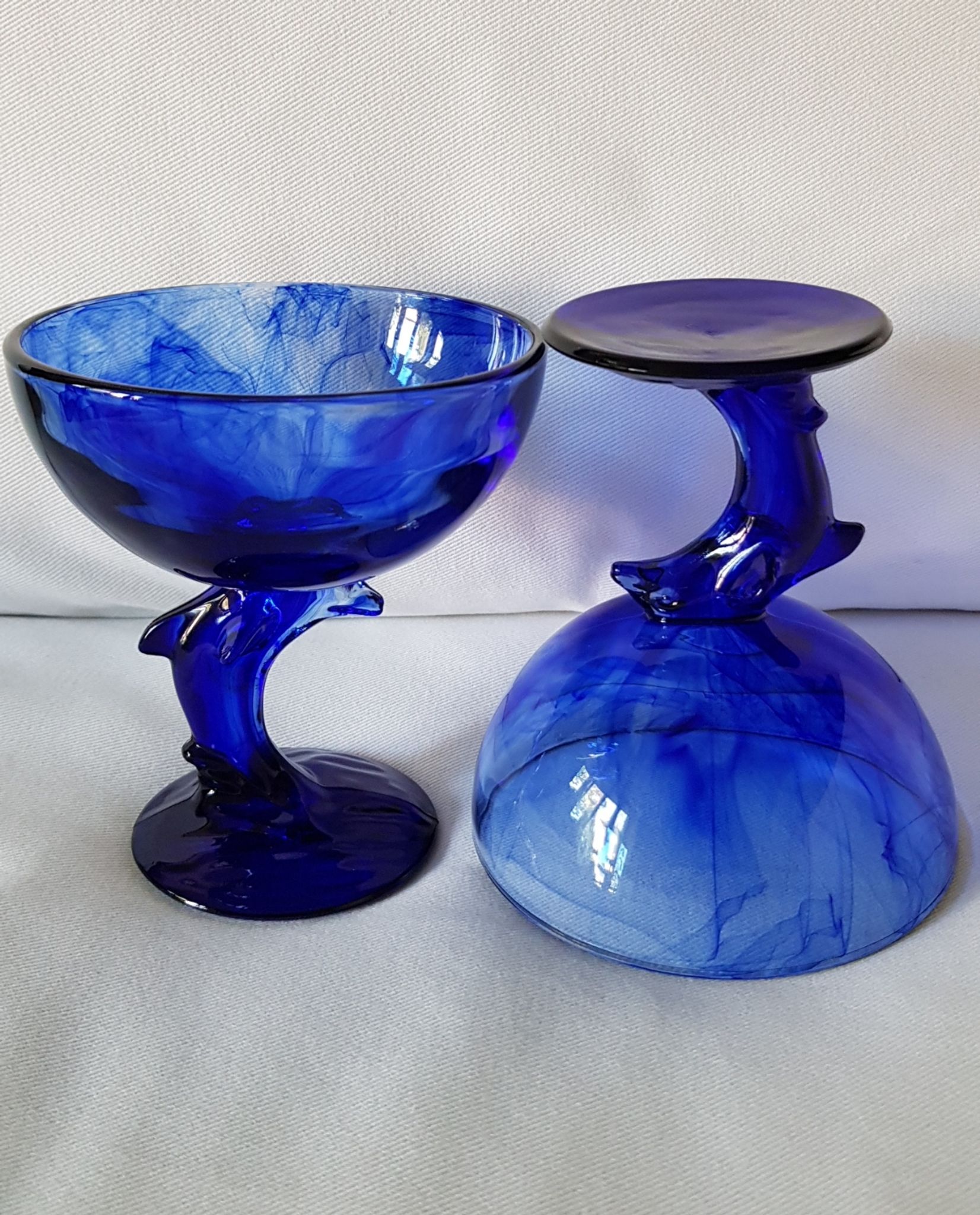 Set of 2 dolphin dessert cups in blue glass.