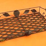 Rectangular metal serving tray with floral decoration.
