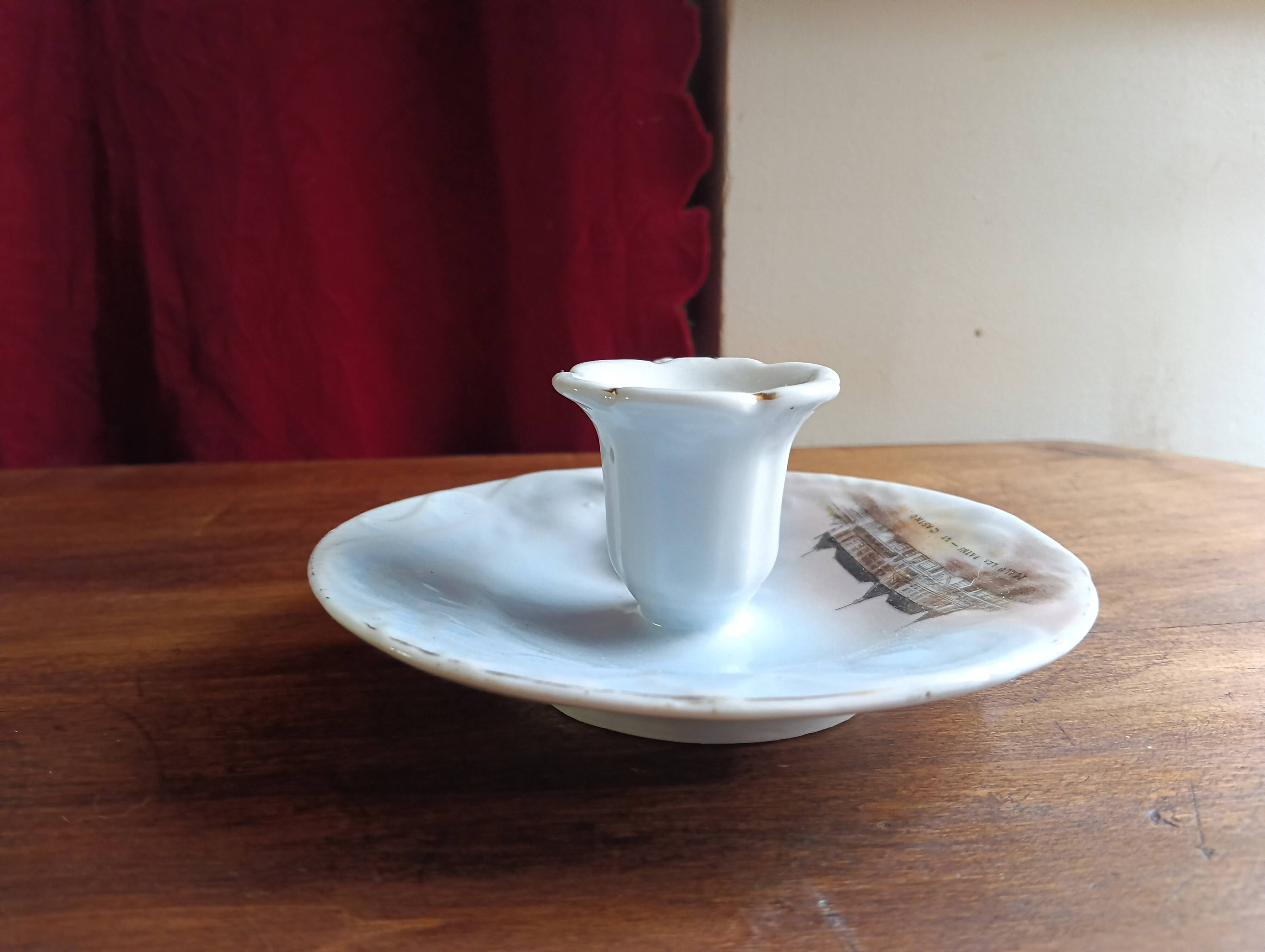 Antique handheld candle holder in porcelain