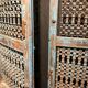 Openwork indian door in metal and blue wood