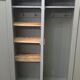Curved wardrobe workshop locker made of wood repainted in grey.