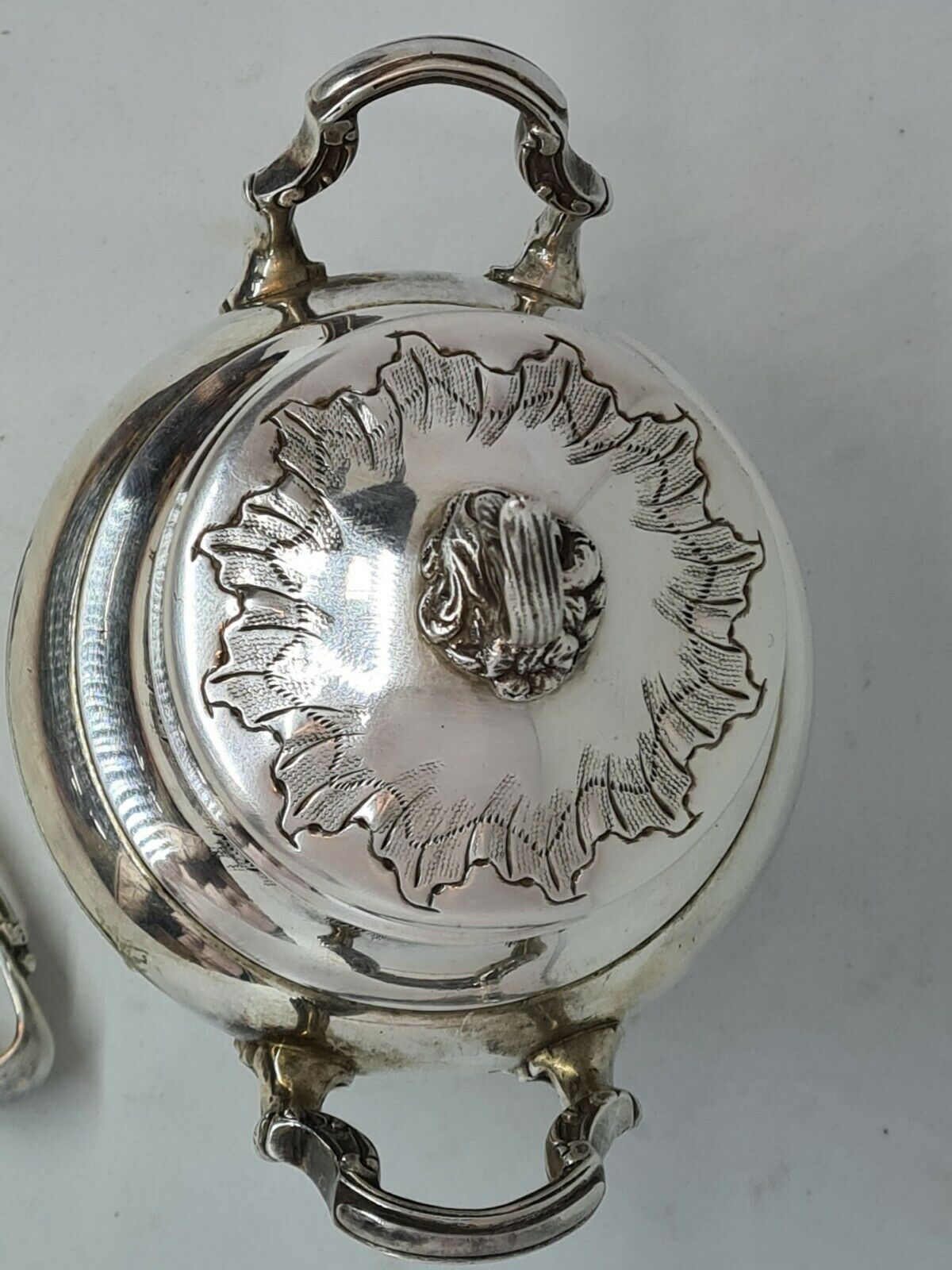 Silver metal sugar bowl with its clamp