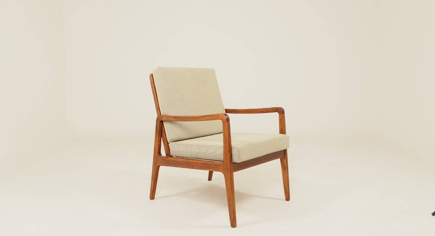 Vintage armchair in olive corduroy with a wooden frame.