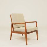 Vintage armchair in olive corduroy with a wooden frame.