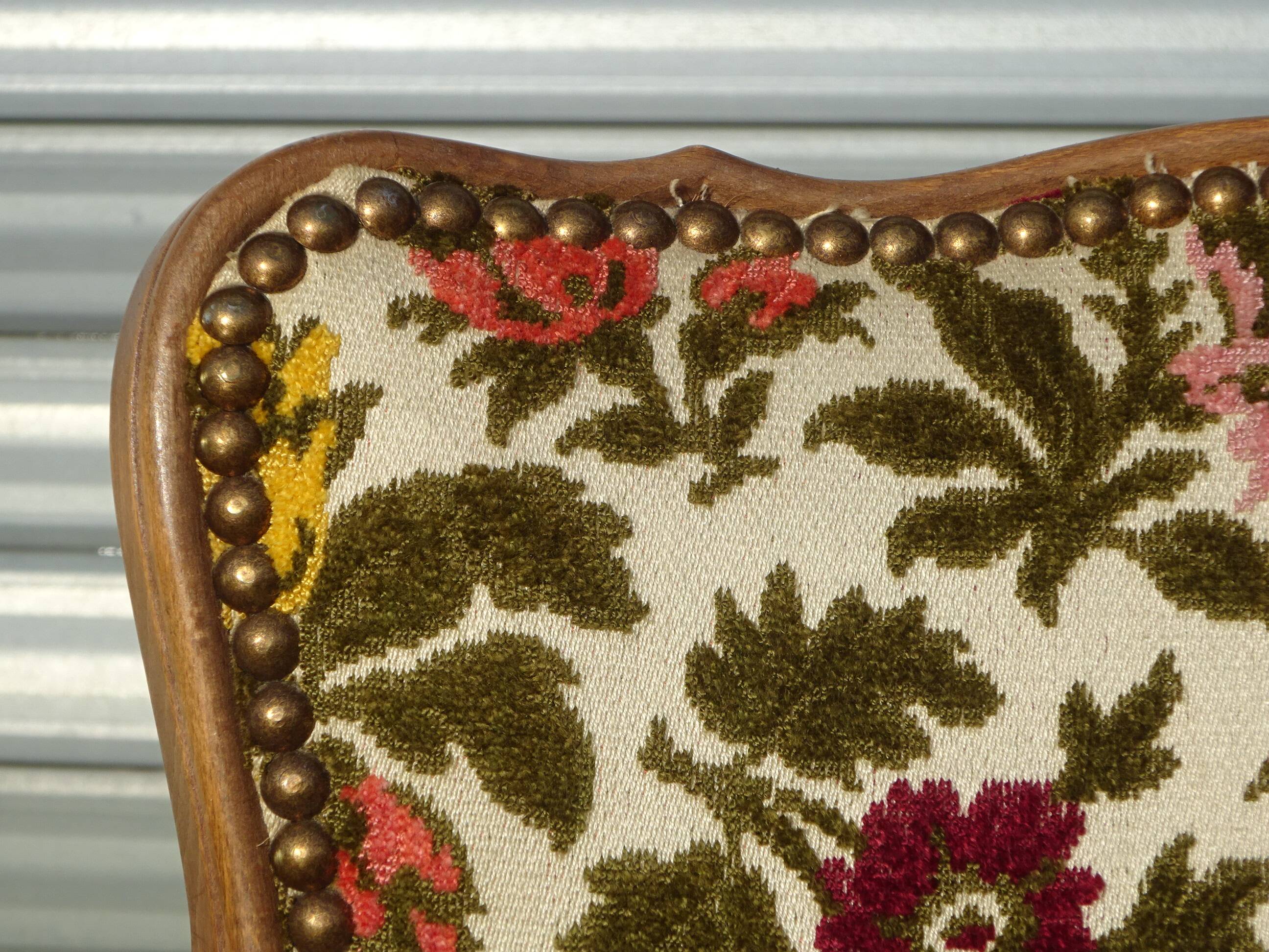 Convertible armchair with brocade fabric and floral patterns.