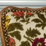 Convertible armchair with brocade fabric and floral patterns.