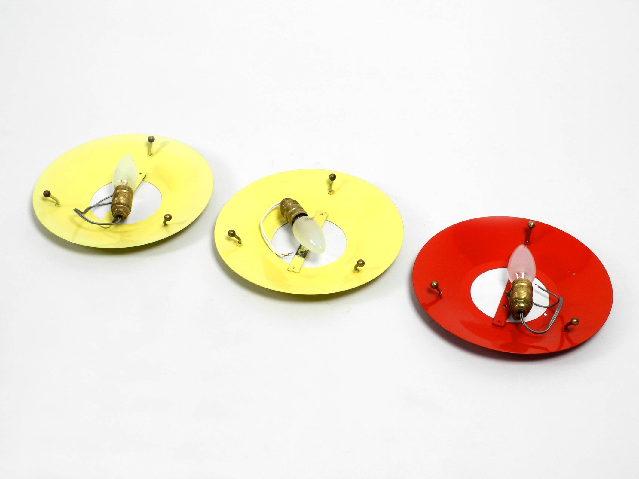 Three round 1950s wall or ceiling lamps made of metal and plexiglass shades