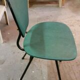 Chair in curved wood covered with vinyl, metal tube.