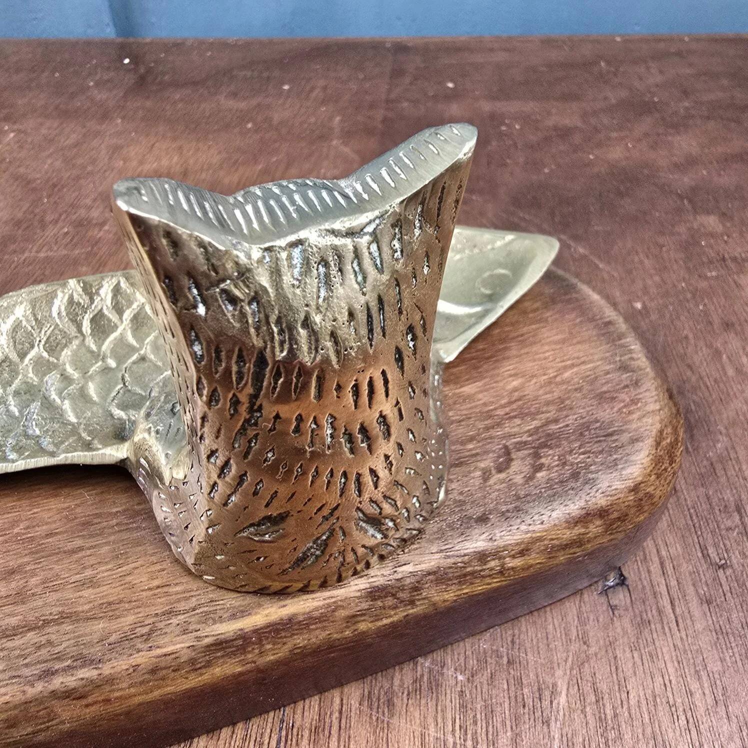 Vintage cat fish catchall in brass on a solid wood base.