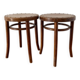 2 antique bistro stools with curved wood and caning effect.