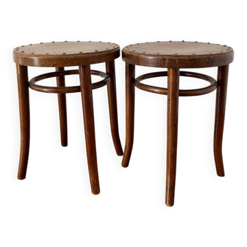 2 antique bistro stools with curved wood and caning effect.