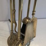 Neoclassical brass fire accessory with duck head decorations.