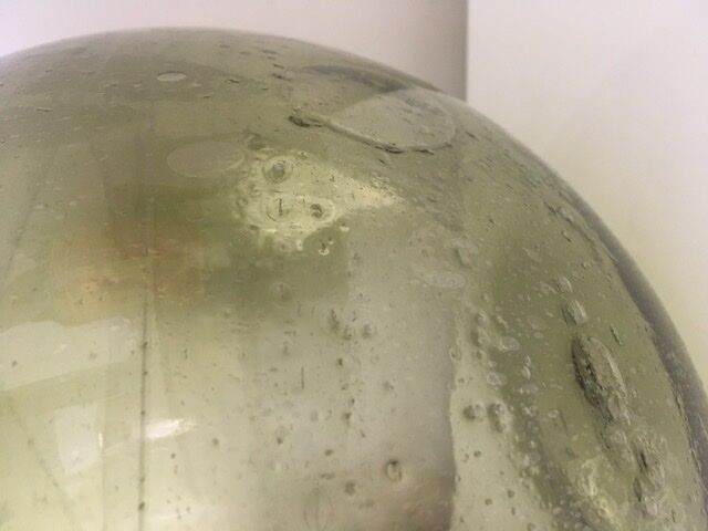 Old demijohn full of bubbles