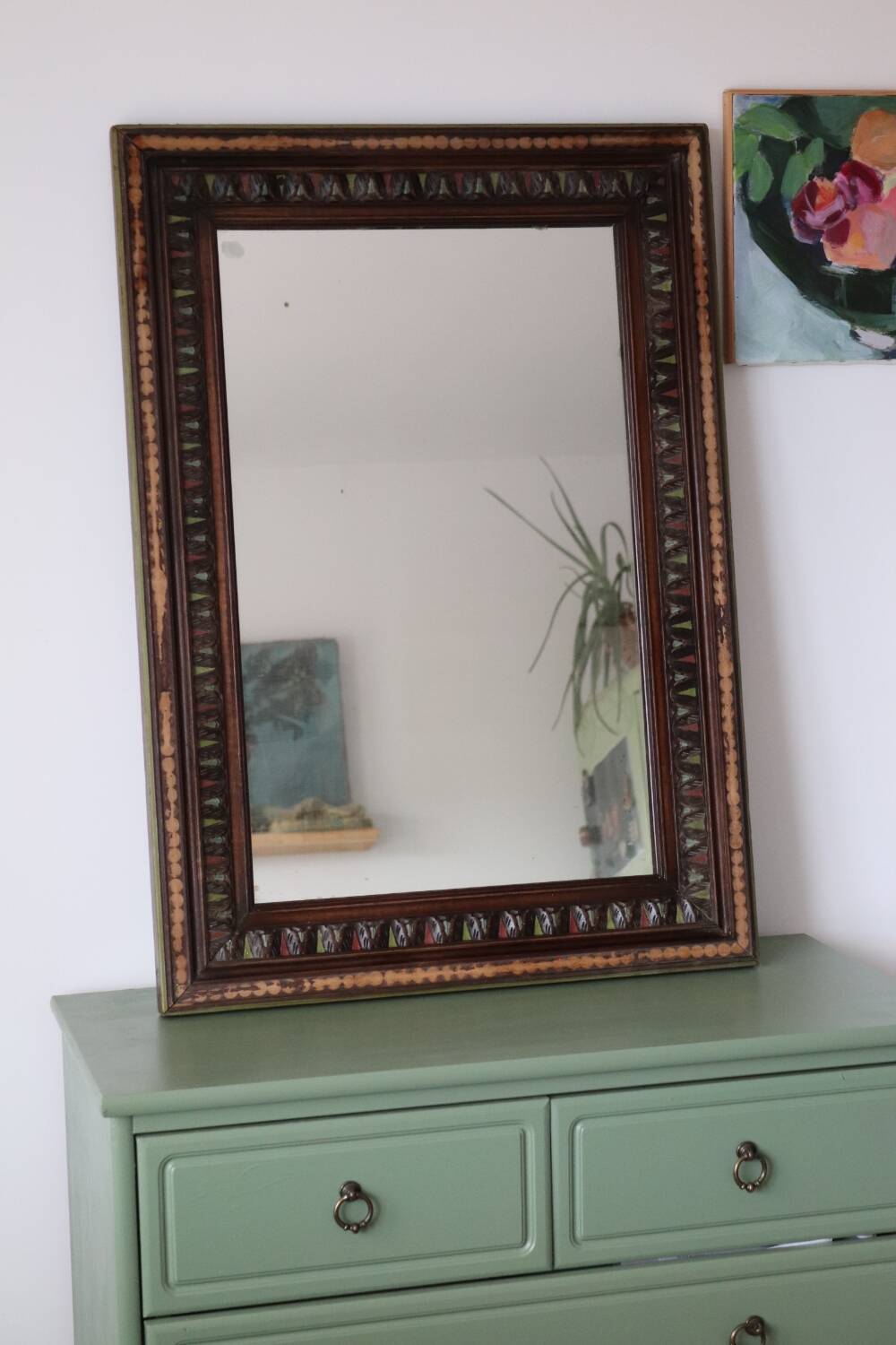 Antique mirror with a carved and painted wooden frame