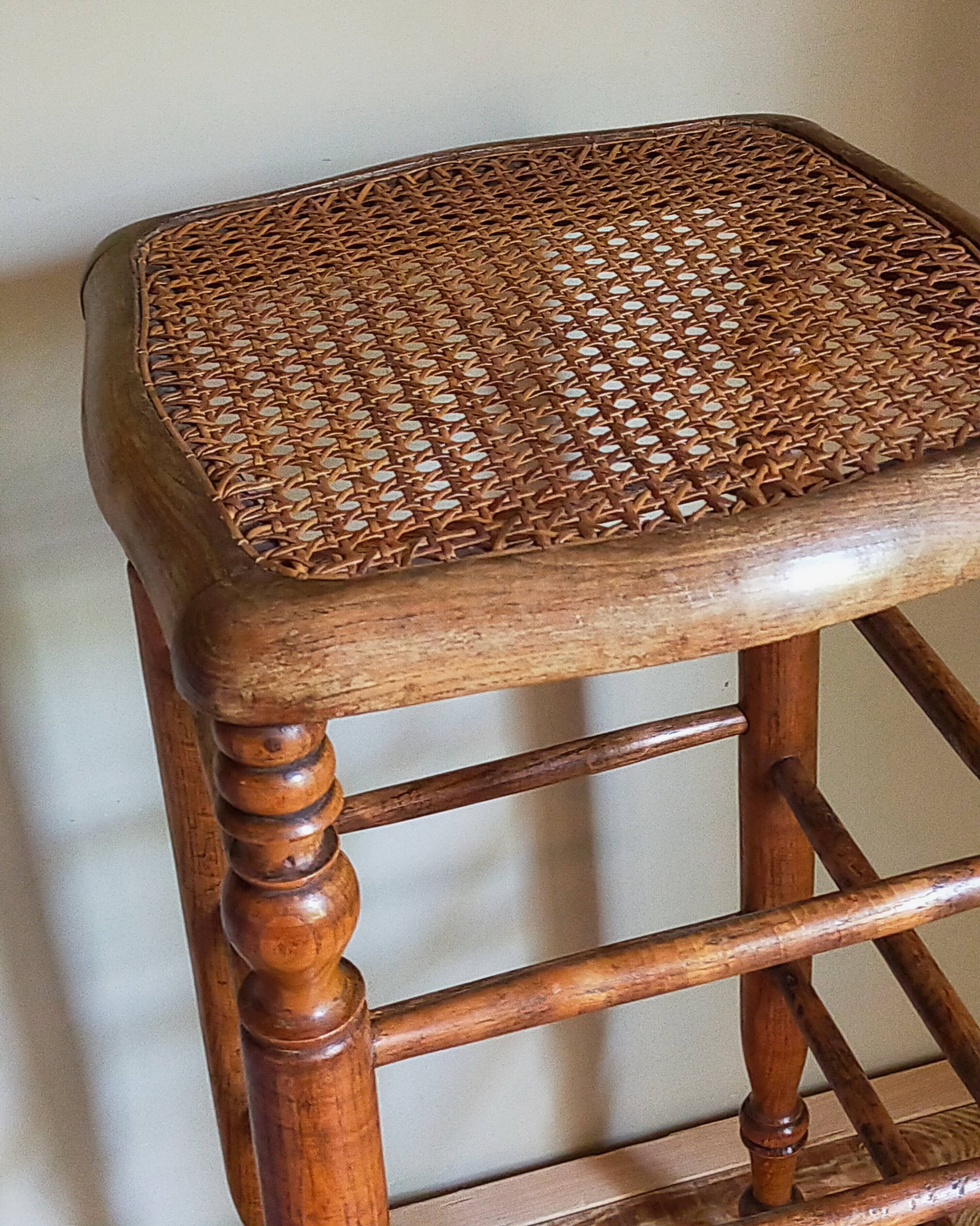 Antique stool with cane and turned wood