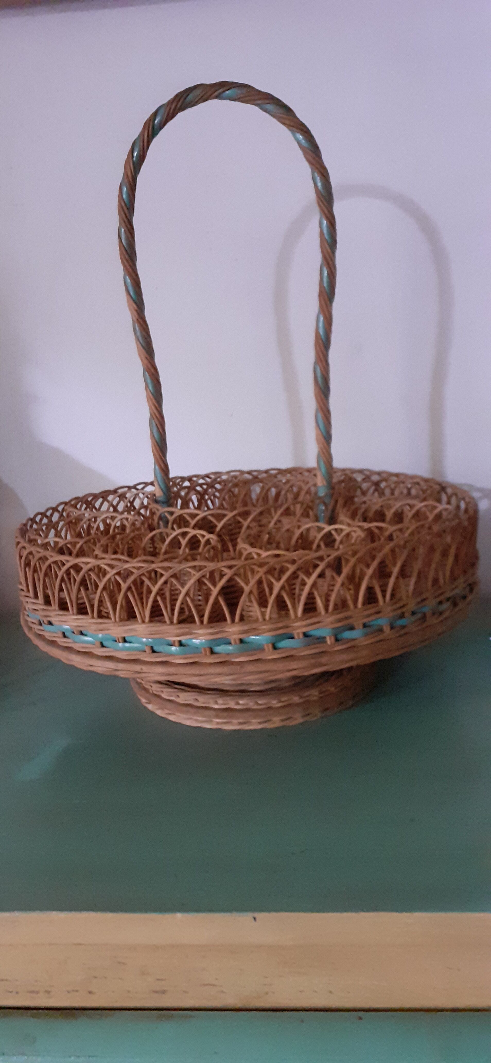 Glass holder and wicker bottle with green plastic water surface
